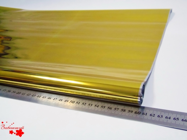 Однотонная пленка фольга для упаковки подарков 60см на 12м. золотого цвета











